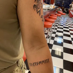 Both of us got Roman numeral tattoos.