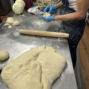 a woman rolling out dough