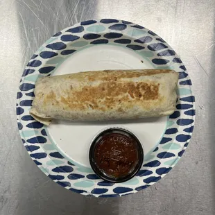 a burrito on a paper plate