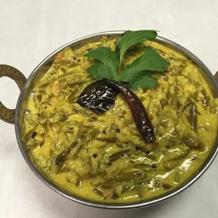 Parsi Bhaji is a mild dish made with green beans, coconut sauce, mustard, curry leaves, mild spices and a splash of cream.