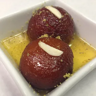 Gulab Jamun - golden fried dough balls, soaked in sweet saffron syrup, served piping hot