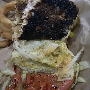 Close up of my grilled mahi blackened sandwich ( cut in half) . Even the tomato was top notch  Did I mention it was $10