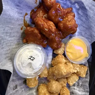 Boneless wings with mild BBQ sauce. Tater tots with nacho cheese dip and a side of ranch for the wings.