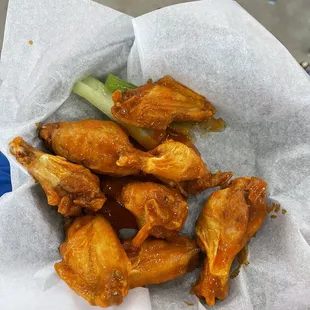 a basket of chicken wings and celery