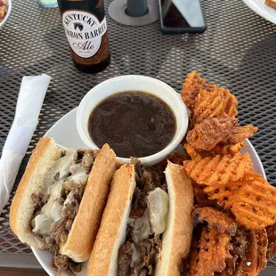 French dip sandwich with sweet potato waffle fries.