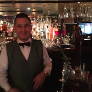 a bartender standing behind a bar