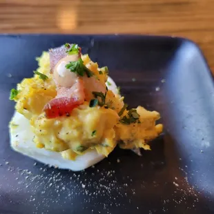 Deviled egg. 6 come with every order-little celery for crunch, plenty of chives, not too mustardy-topped with bacon and a dab of spicy mayo