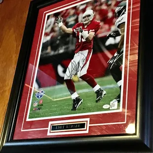 Signed Kurt Warner pic above our table.