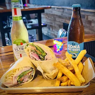 a plate of food and a bottle of soda