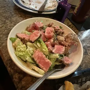 She cut up her tuna and added it to her Caesar side salad