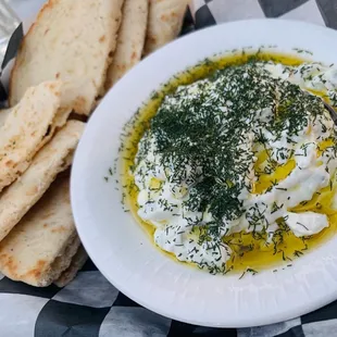 a bowl of hummusle and pita bread