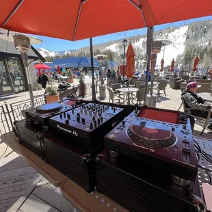 two dj&apos;s under an umbrella