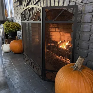 a fireplace with pumpkins and gourds
