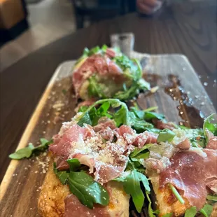 a piece of bread with ham and spinach