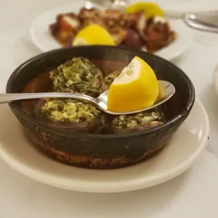 a bowl of soup with a lemon wedge