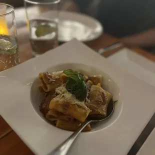 a plate of pasta and a glass of water