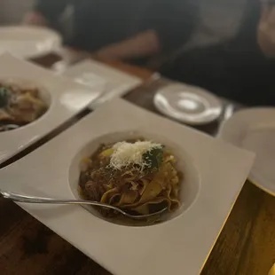a plate of pasta and a glass of wine