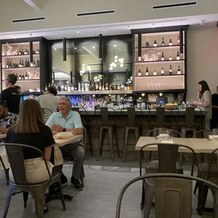 people sitting at tables in a restaurant