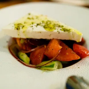HORIATIKI SALATA Greek village salad / heirloom tomatoes / cucumbers / feta / olives