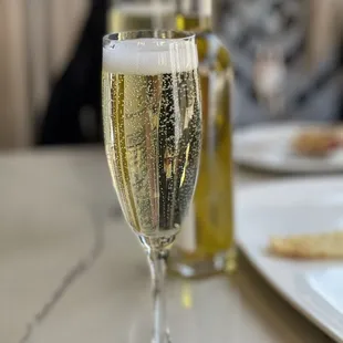 a glass of champagne on a table