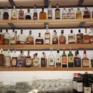 shelves of liquor bottles and glasses