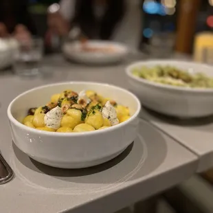 two bowls of food on a table