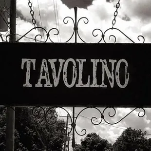 a black and white photo of a street sign