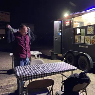 a man standing in front of a food truck