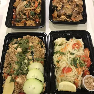 Clockwise from top left: Basil stir fry with tofu, drunken noodles with chicken, papaya salad, basil fried rice.