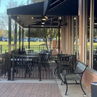 Outdoor dinning from side wrapped around the back. Plenty of seating.