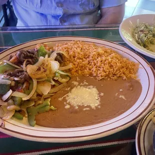 Lunch portion of Trio Fajitas (with the included almost finished salad in the background)
