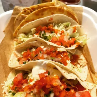 three tacos on a paper plate