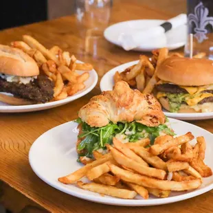 two plates of burgers and french fries