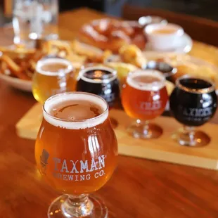 a flight of beer and snacks