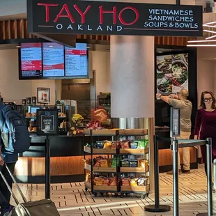 a woman pulling her luggage through the airport