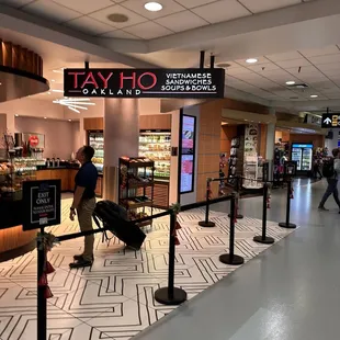 people walking through an airport with luggage