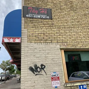 a brick building with graffiti on it