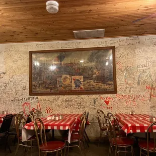 tables and chairs with red and white checkered tablecloths