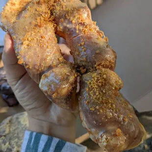 a hand holding a doughnut