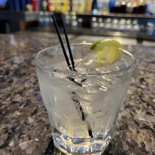 a gin cocktail with a lime wedge