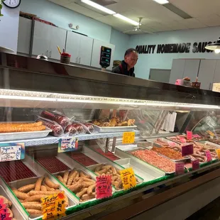 a variety of sausages in a display case
