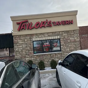 two cars parked in front of the restaurant