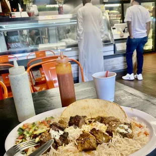 Lamb tikka kabob meal (21.99) meat counter in front.