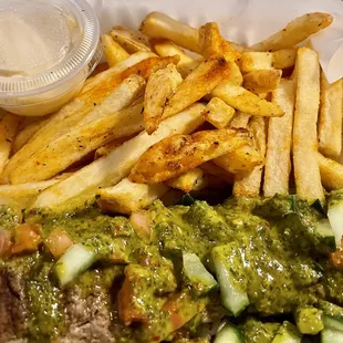 a plate of food with french fries and guacamole