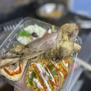  hand holding a plastic container of food