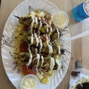 Chicken kabobs over yellow rice