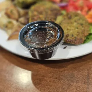 Build-your-own feats featuring falafel, salad, potato and pita chip.