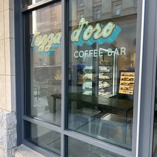the reflection of a coffee shop window