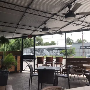 a patio area with tables and chairs