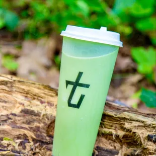 a cup of coffee on a log